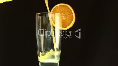 Orange juice pouring into a glass