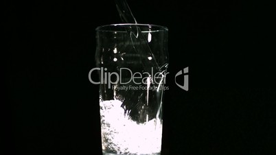 Water filling in glass in slow-motion