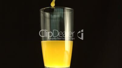 Orange juice filling a big glass