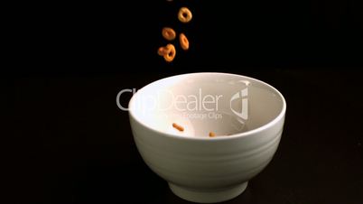 Circular cereal being poured into a bowl