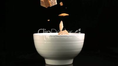 Square cereal falling into bowl