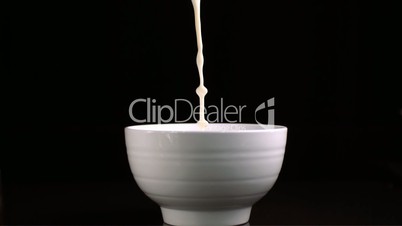 Milk pouring in a bowl