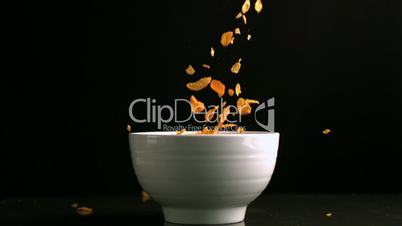 Cereal falling in a white bowl