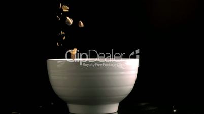 Bowl being filled by muesli