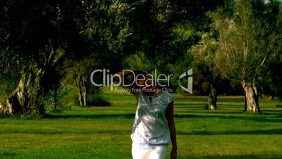 Woman walking in the wind and touching her hair