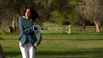 Woman walking in the wind and wrapping up