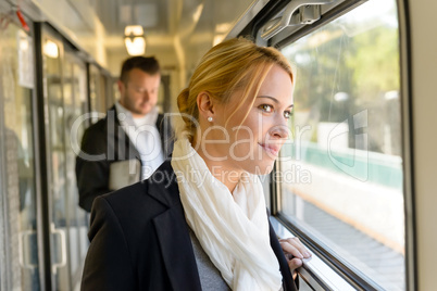 Woman in train looking pensive on window