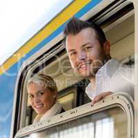 Man and woman in train looking window