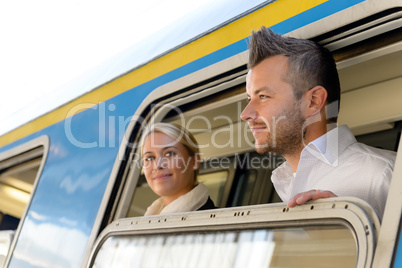 Man and woman looking out train window