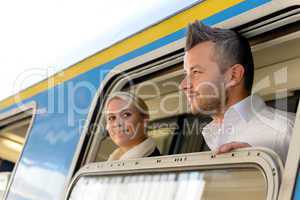 Man and woman looking out train window
