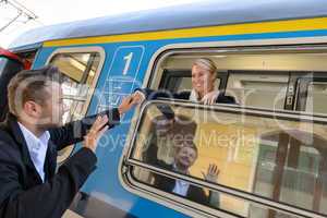 Man saying goodbye to woman on train