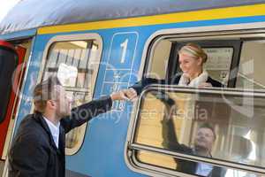 Woman leaving with train man holding hand