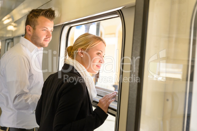 Woman and man looking out train window