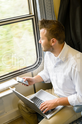 Man looking out the train window thinking