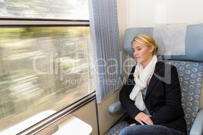Woman asleep in train compartment tired resting