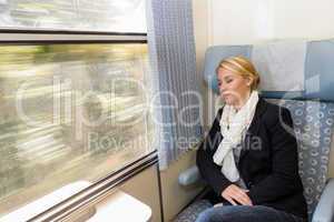 Woman asleep in train compartment tired resting