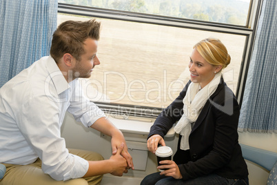 Woman and man traveling with train talking