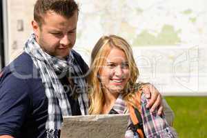Couple together on holiday with map happy