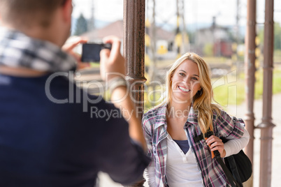 Woman smiling man taking her picture vacation