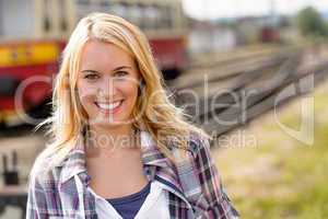 Woman smiling looking at camera vacation railroad