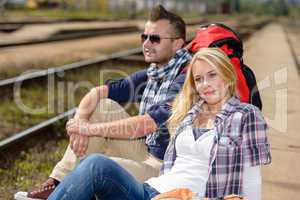 Couple backpack traveling resting on railroad trip
