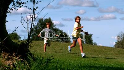 Two children running in park