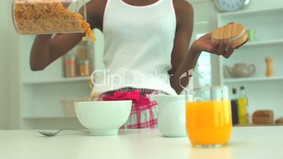 Woman pouring cereal in a bowl