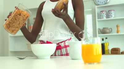 Woman pouring cereal for breakfast