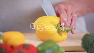 Woman slicing a peppper