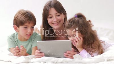 Mother and her children using tablet pc