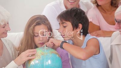 Extended family looking at globe