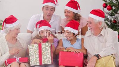 Excited family exchanging gifts at christmas