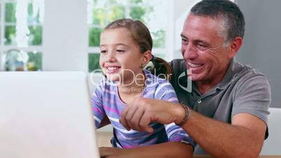 Grandfather and girl using laptop