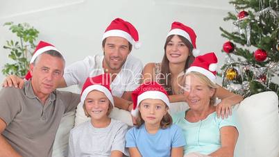 Happy family at christmas holding gifts