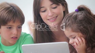 Mother and her children using tablet pc together