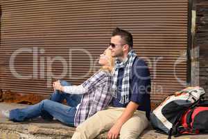 Couple resting backpack travel tired sitting trip