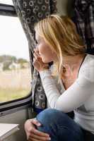 Woman smiling and looking out train window