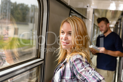 Woman looking out the train window smiling