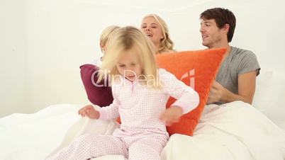 Family playing with pillows