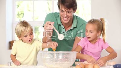 Father and children breaking eggs