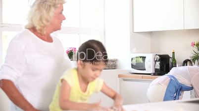 Mother taking cookies of the oven