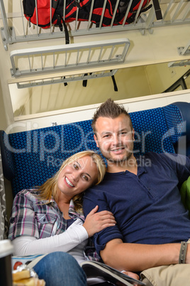 Woman leaning on man's shoulder in train