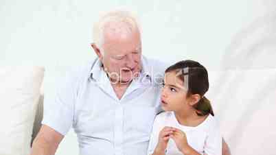 Grandpa speaking with his granddaughter