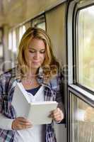Woman reading book on train hall vacation
