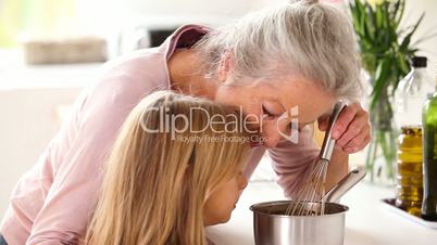 Granny and little girl making chocolate sauce together