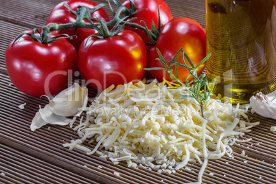 Grated cheese and tomatoes on a board