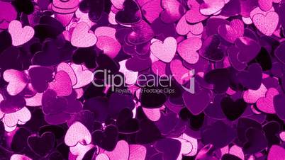 Purple heart shaped confetti changing color