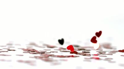 Red heart confettis falling down