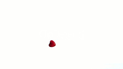 One red heart confetti dropping on the floor