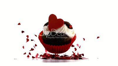 Beautiful valentines cupcakes falling on piles of confetti